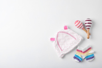 Flat lay composition with baby clothes and space for text on white background