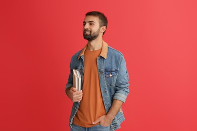 Photo of Happy student with books on red background