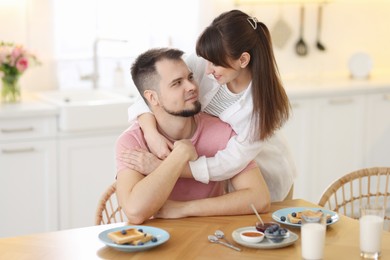 Photo of Lovely couple spending time together during breakfast at home