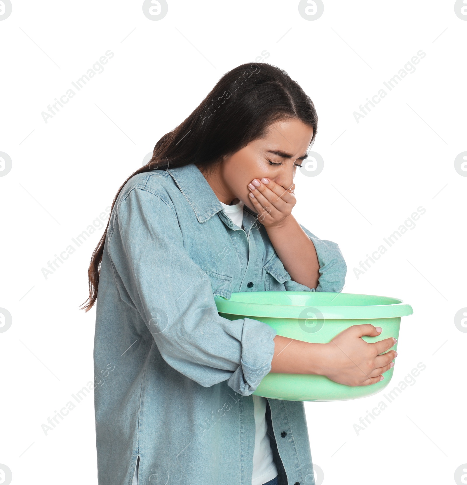 Photo of Young woman with basin suffering from nausea on white background. Food poisoning