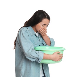 Photo of Young woman with basin suffering from nausea on white background. Food poisoning