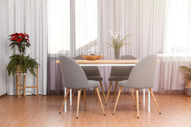 Photo of Window with stylish curtains in living room interior