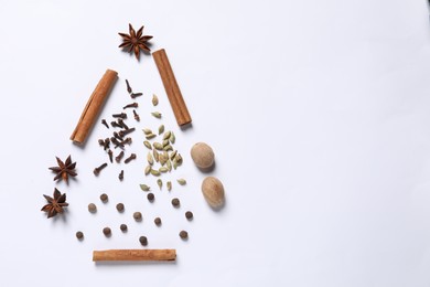 Photo of Christmas tree made of different spices on white table, flat lay. Space for text