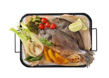 Delicious roasted dorado fish with vegetables, herbs and lime isolated on white, top view