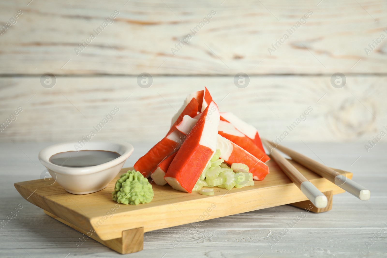Photo of Cut crab sticks served on wooden table