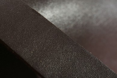 Photo of Dark brown leather as background, closeup view