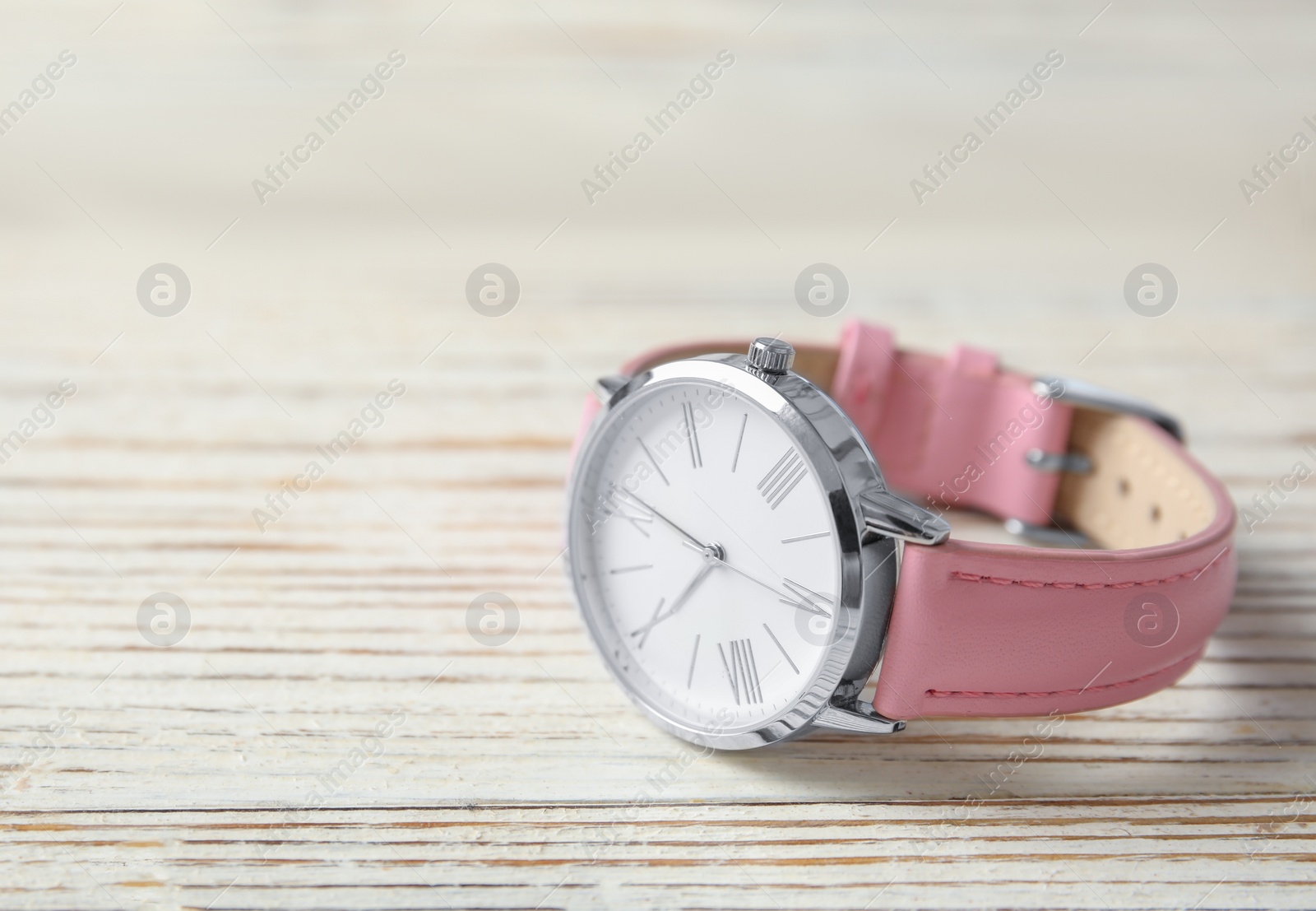 Photo of Stylish women's wrist watch on wooden table, space for text. Fashion accessory