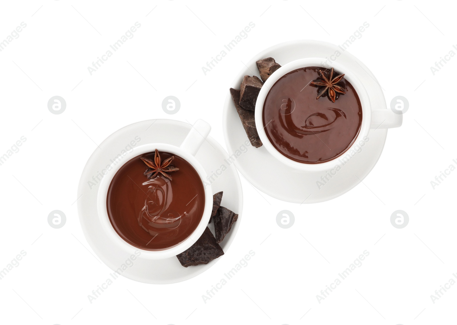 Photo of Cups of delicious hot chocolate with anise stars on white background, top view