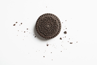 Tasty chocolate cookie and crumbs on white background, top view