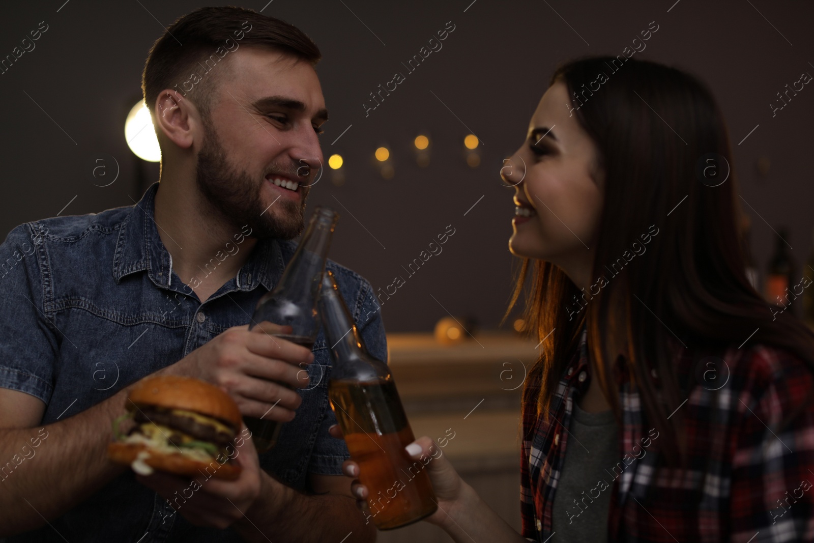 Photo of Young couple having lunch in burger restaurant