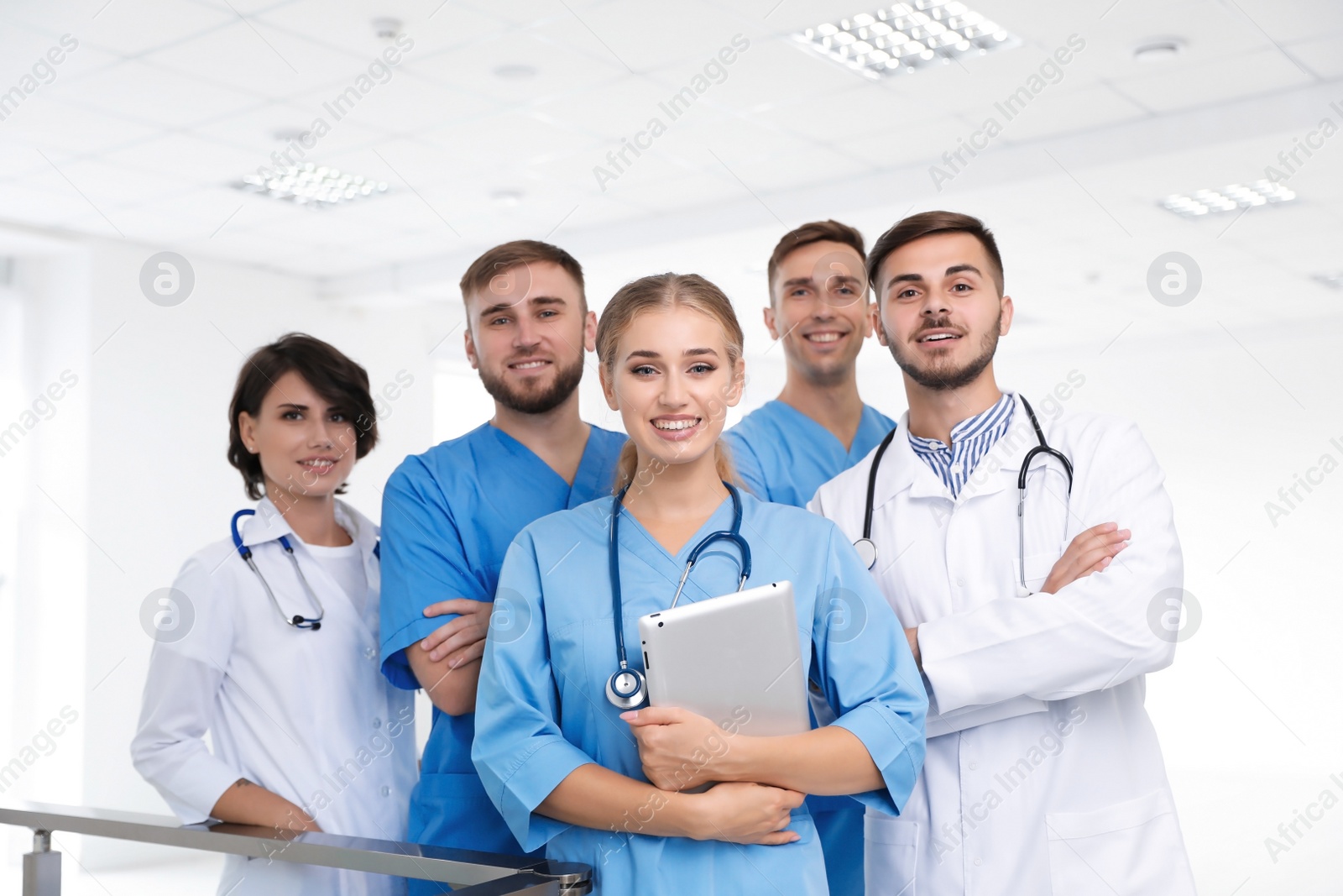 Photo of Team of doctors with tablet at workplace