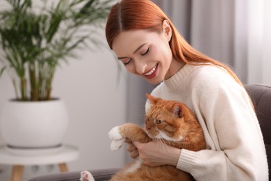 Happy woman with her cute cat at home