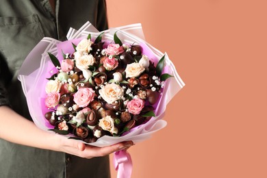 Photo of Woman with beautiful food bouquet on brown background, closeup. Space for text