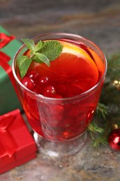 Photo of Aromatic Christmas Sangria in glass on table, closeup