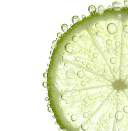 Fresh lime slice in sparkling water on white background, closeup