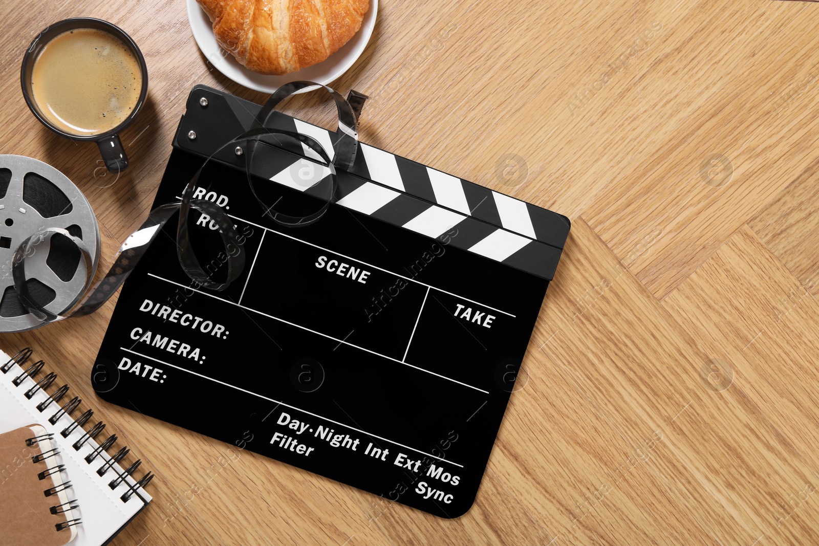 Photo of Flat lay composition with movie clapper on wooden table, space for text
