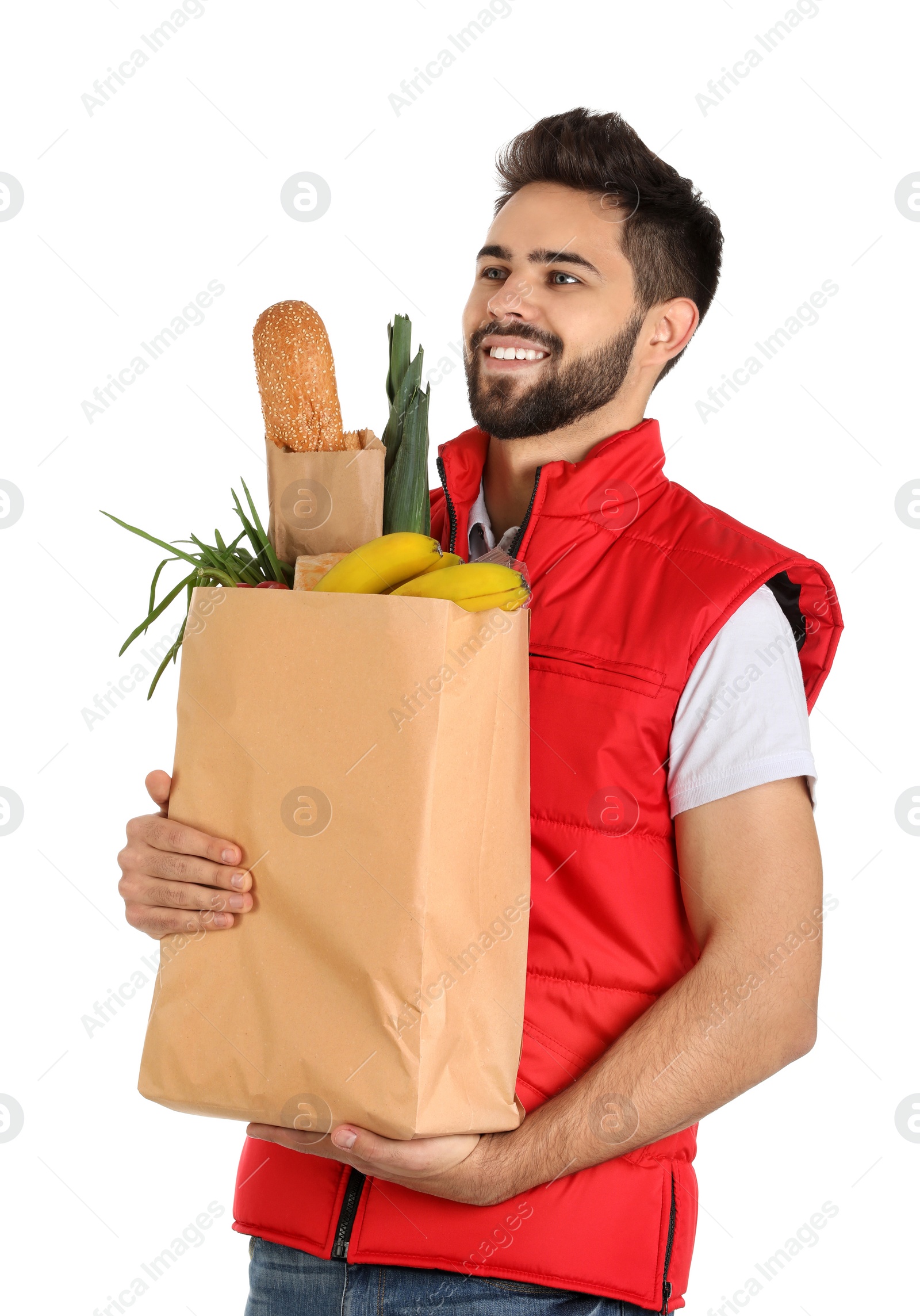 Photo of Man holding paper bag with fresh products on white background. Food delivery service