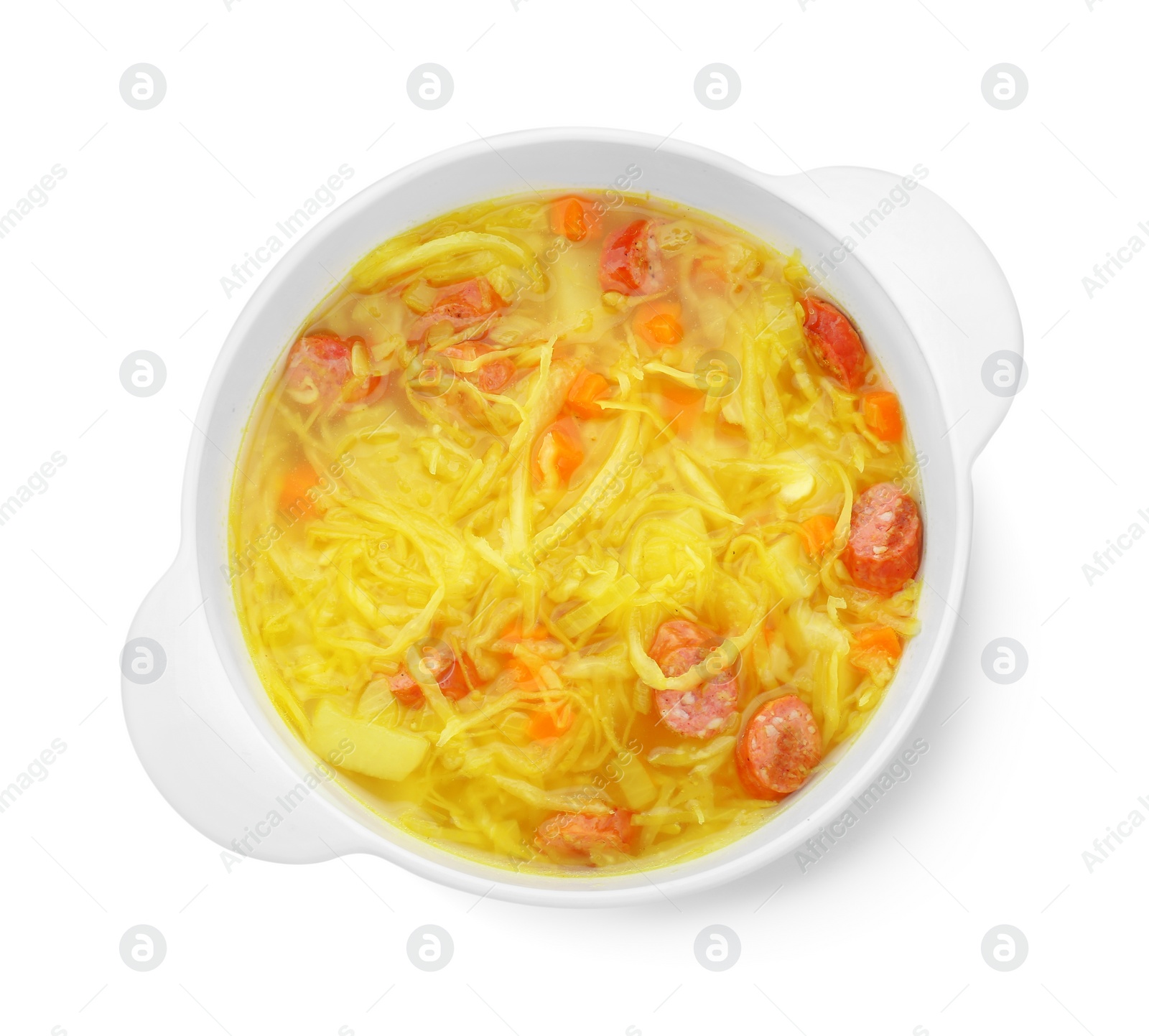 Photo of Bowl of delicious sauerkraut soup with smoked sausages isolated on white, top view