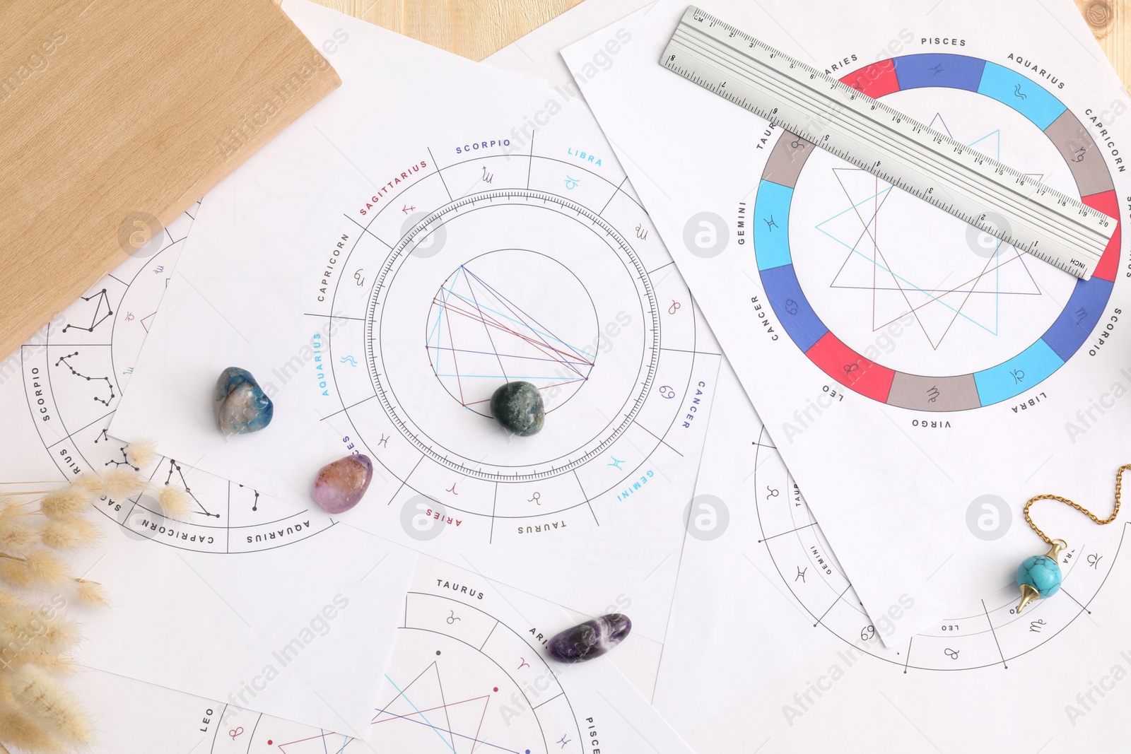 Photo of Natal charts for making forecast of fate and astrological items for fortune telling on table, flat lay