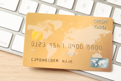 Photo of Online payment concept. Bank card on computer keyboard, closeup