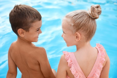 Photo of Cute little children at outdoor swimming pool