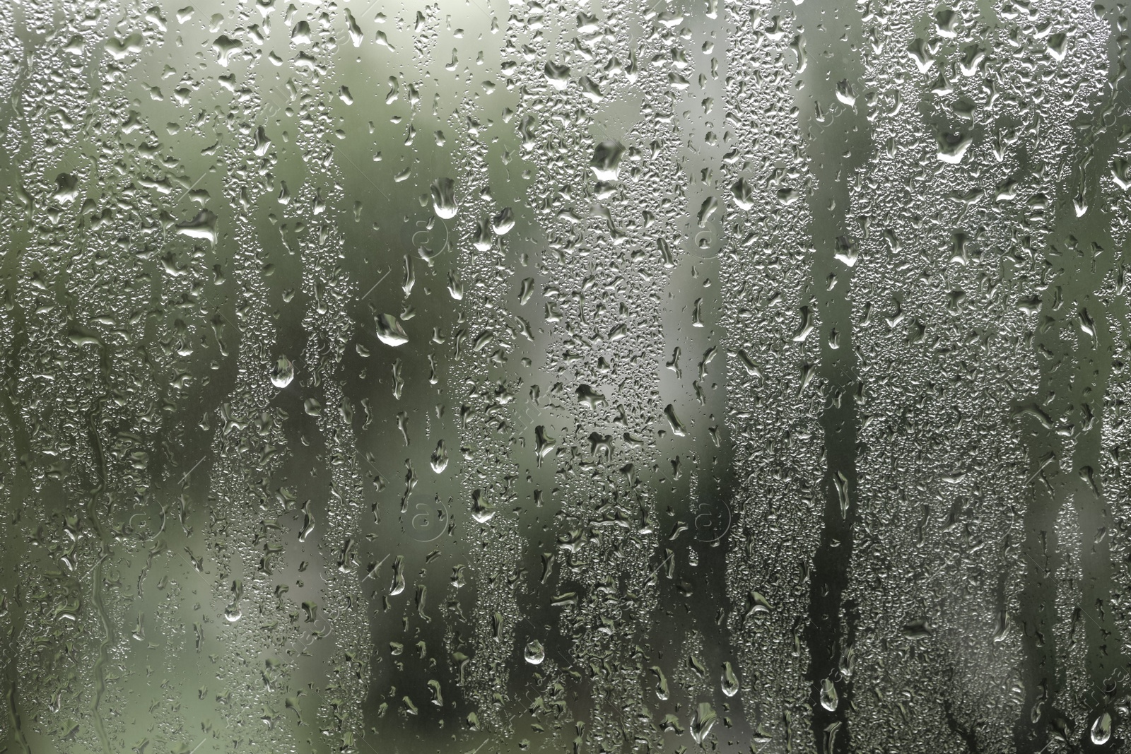 Photo of Window glass with raindrops as background, closeup