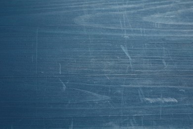 Photo of Old blue wooden surface with scratches as background, closeup