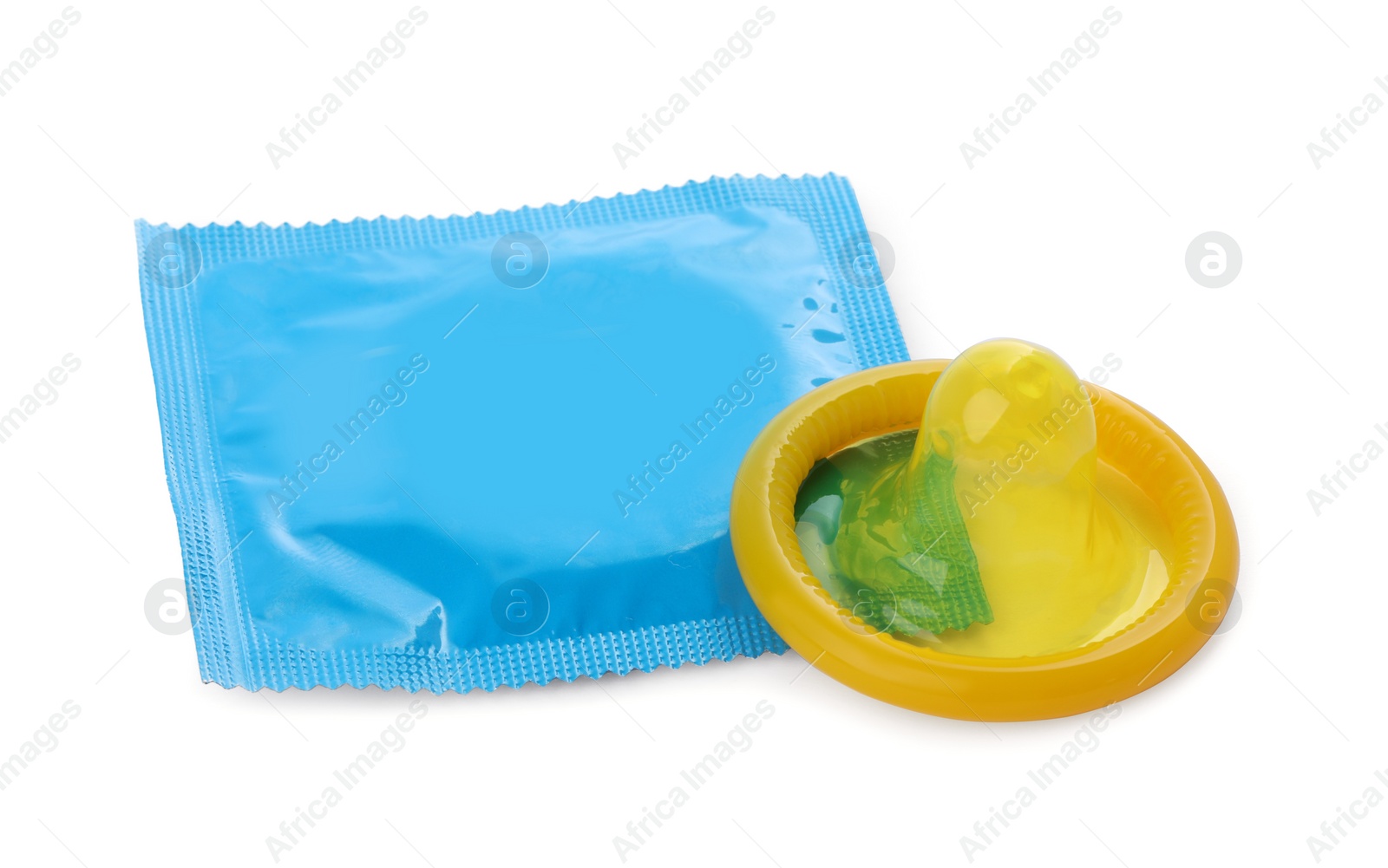 Photo of Package and unpacked yellow condom isolated on white. Safe sex