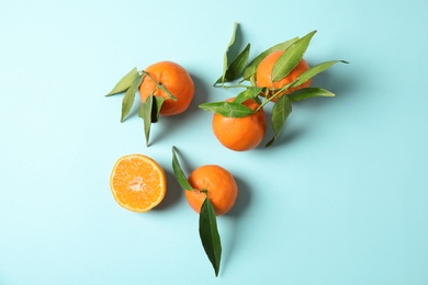 Flat lay composition with ripe tangerines on color background