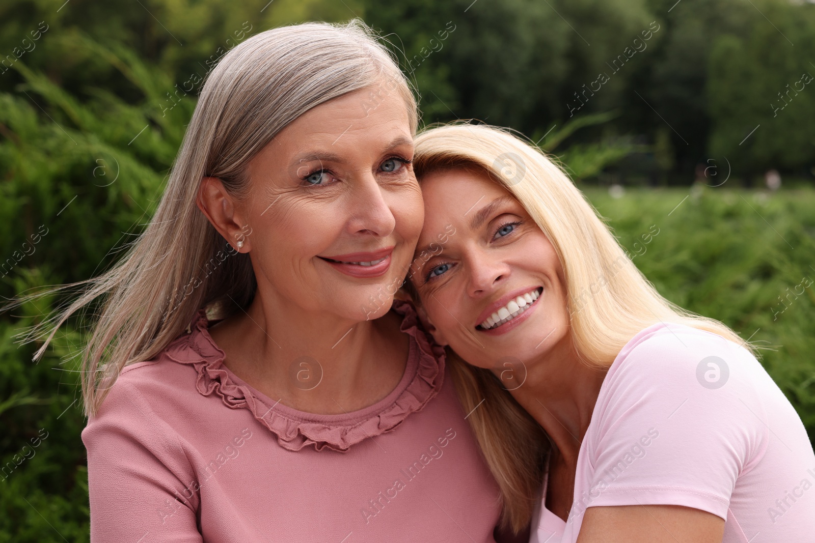 Photo of Happy mature mother and her daughter outdoors