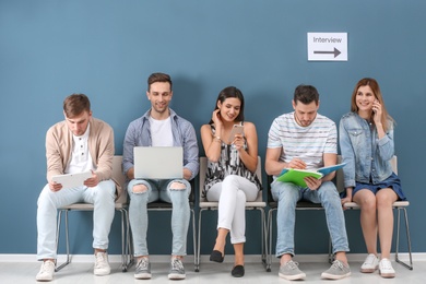 Photo of Group of people waiting for job interview, indoors