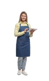 Photo of Beautiful young woman in denim apron with tablet on white background