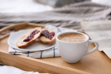 Photo of Morning coffee and sandwiches on tray in bedroom. Space for text