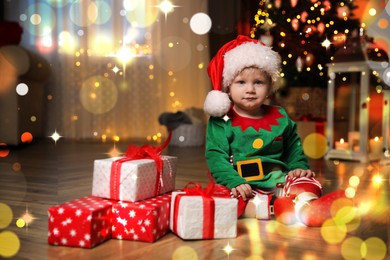Image of Baby wearing cute Christmas costume with gifts at home