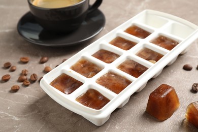 Photo of Ice cubes and coffee beans on grey table