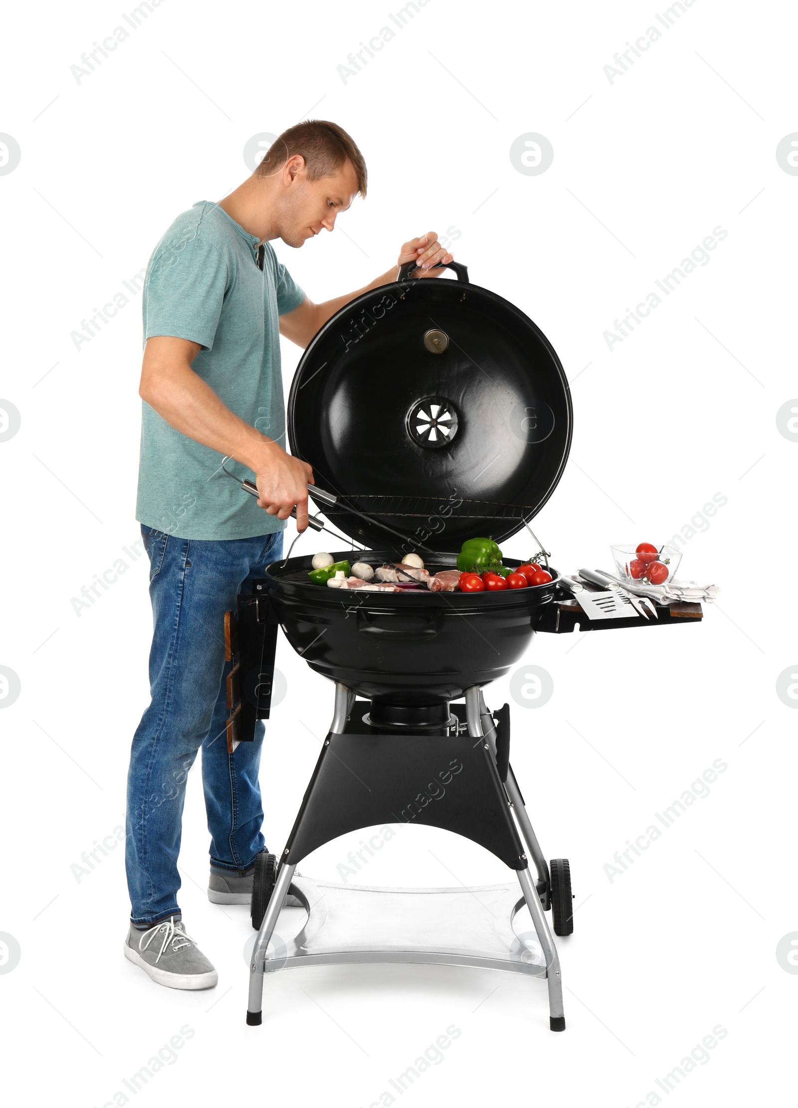 Photo of Man cooking on barbecue grill, white background