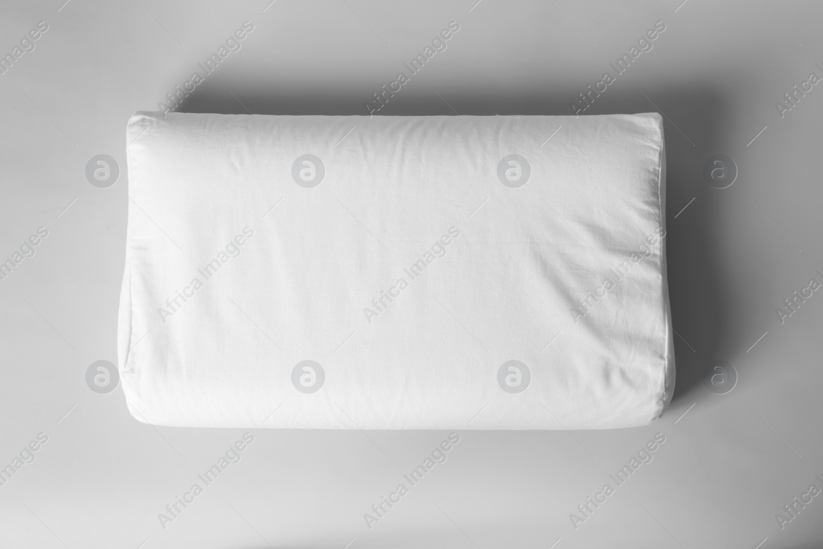 Photo of Blank soft pillow on light background