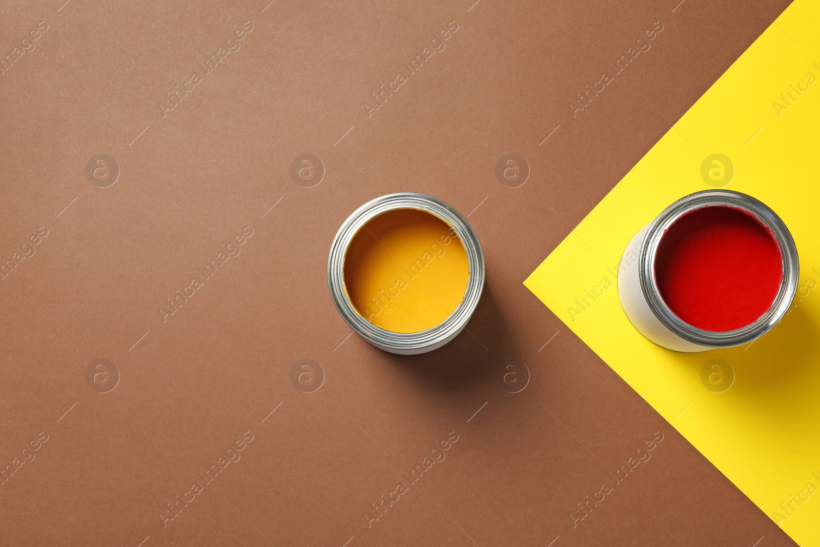 Photo of Flat lay composition with paint cans and space for text on color background