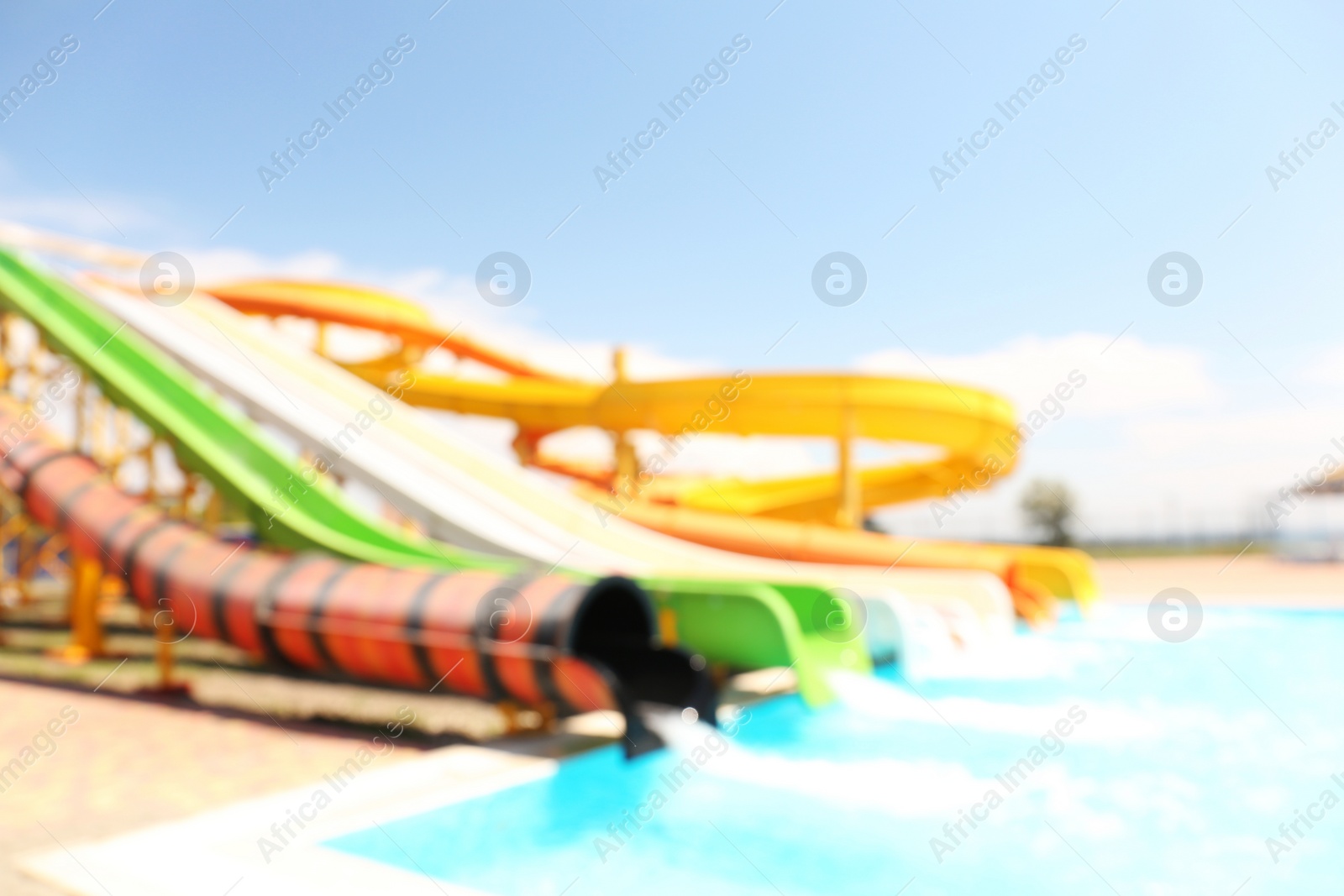 Photo of Different colorful slides in water park, blurred view