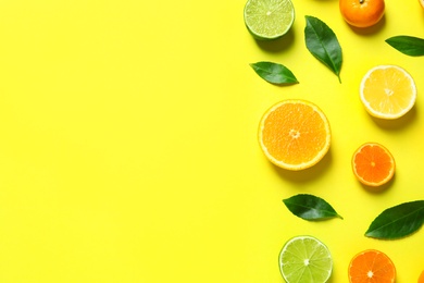 Photo of Different citrus fruits and leaves on color background, flat lay. Space for text