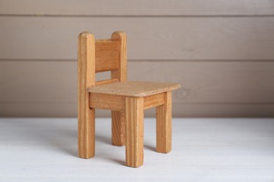 One small toy chair on white wooden table