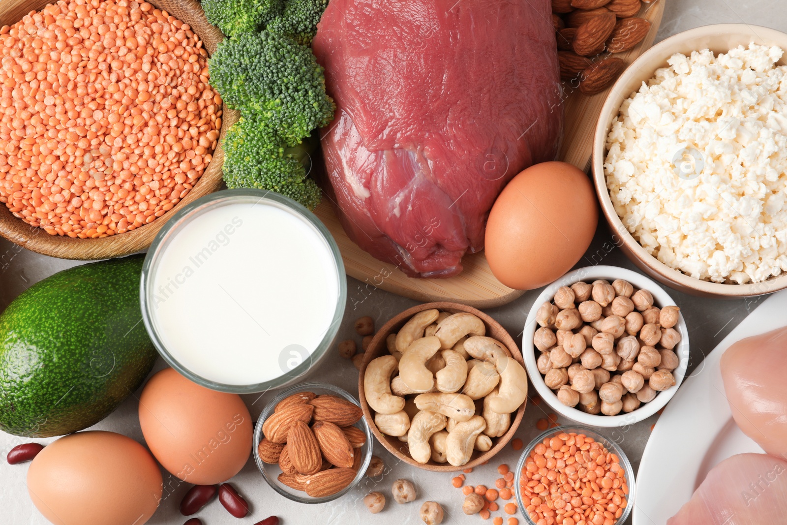 Photo of Set of natural food high in protein on grey background, top view