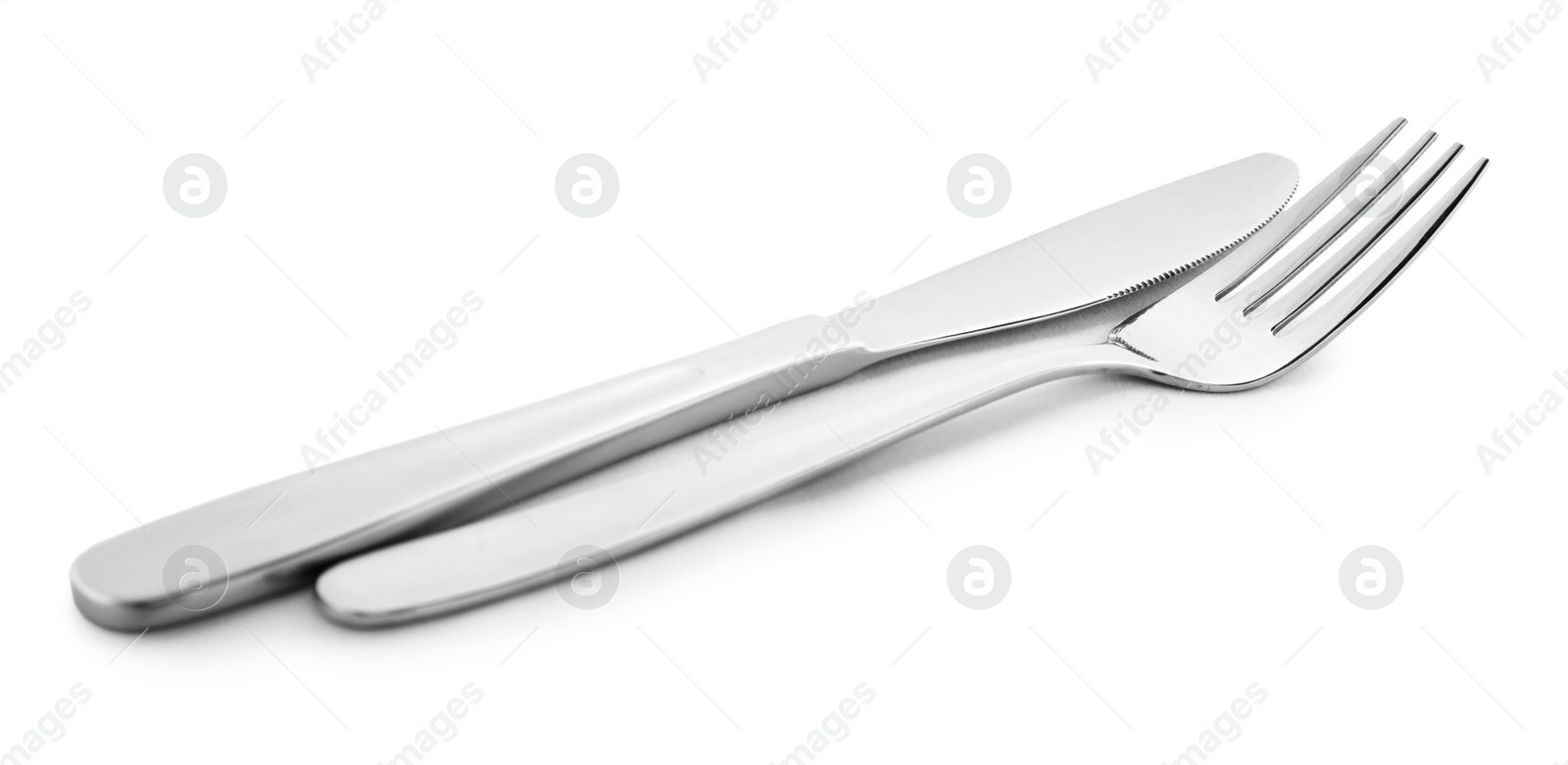 Photo of New clean shiny cutlery isolated on white