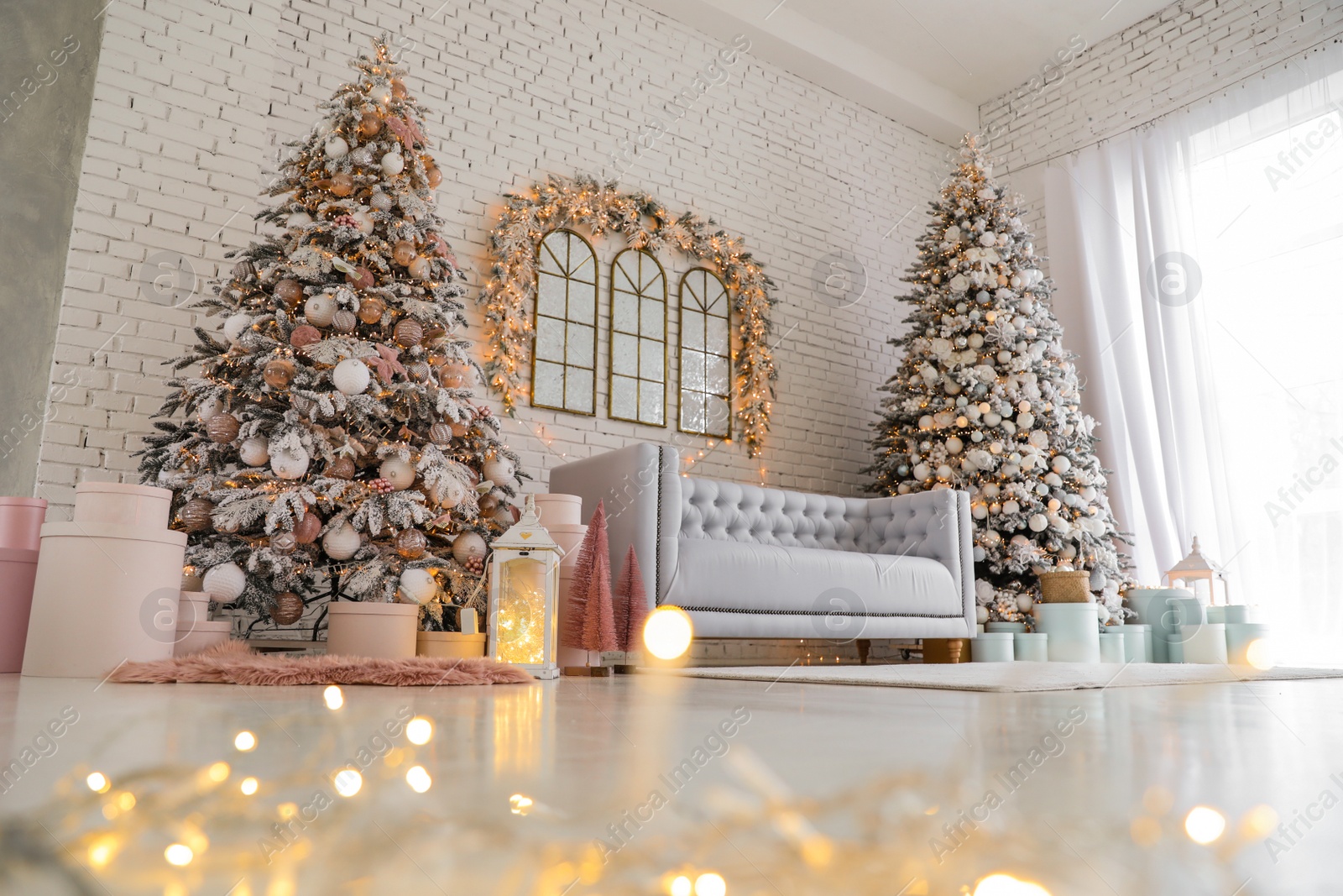 Photo of Beautiful interior of living room with decorated Christmas trees, low angle view