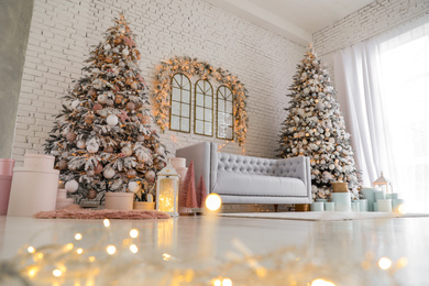 Photo of Beautiful interior of living room with decorated Christmas trees, low angle view