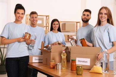Portrait of volunteers packing food products in warehouse