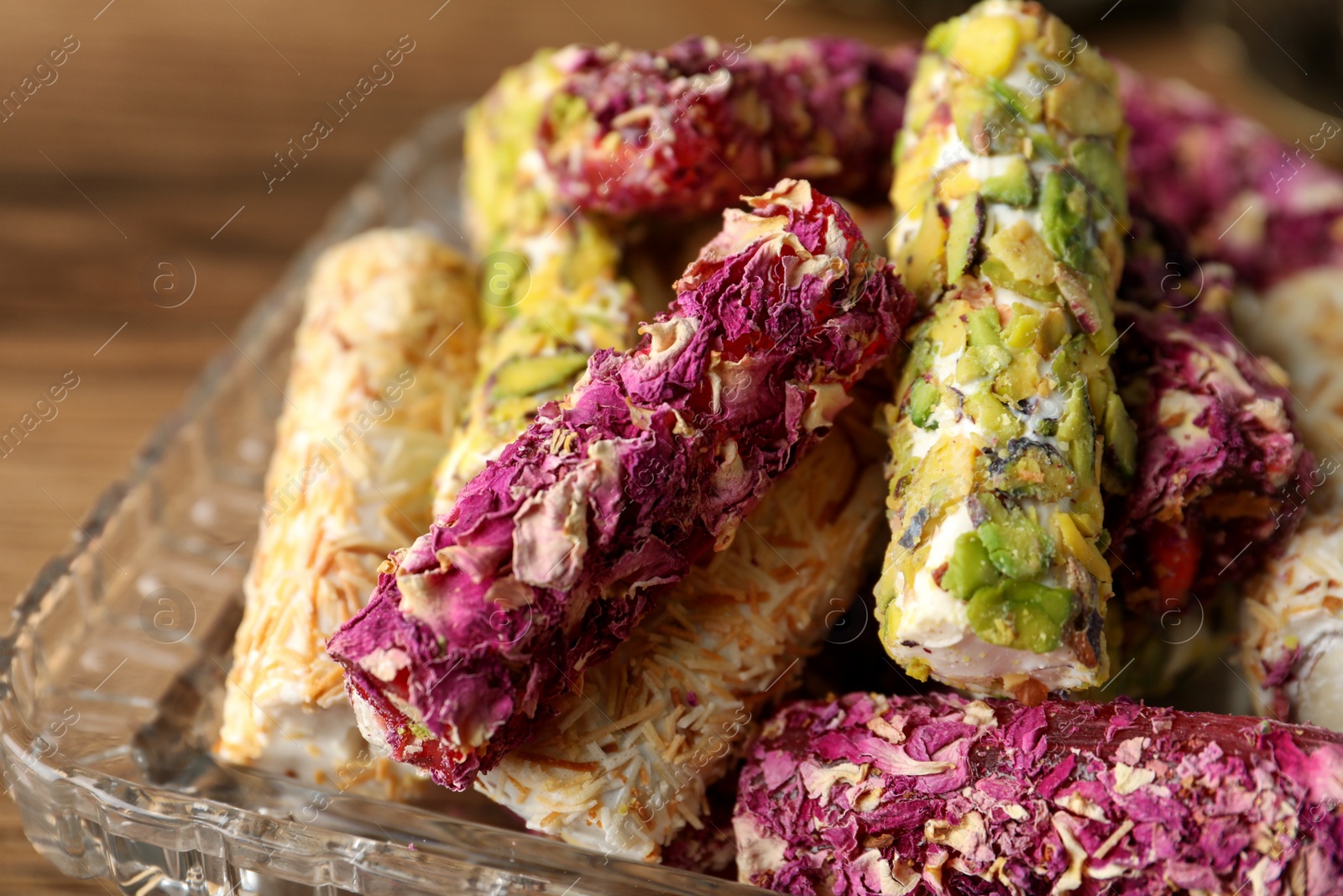 Photo of Turkish delight dessert on wooden table, closeup