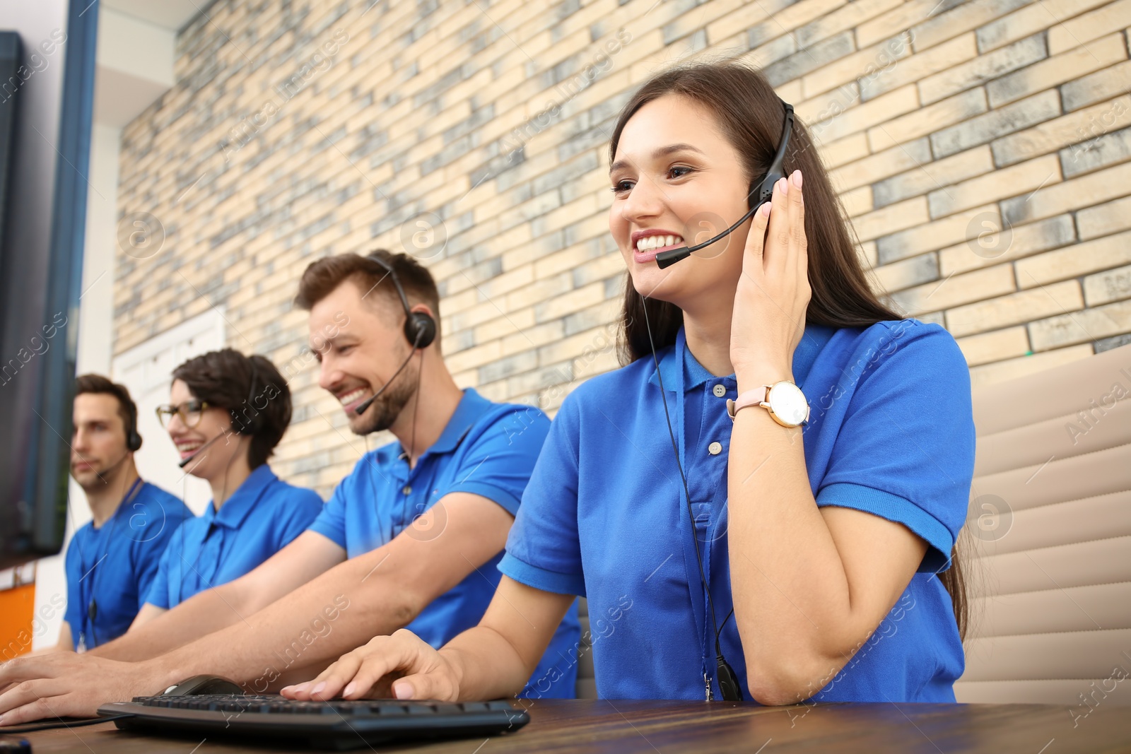 Photo of Technical support operators with headsets at workplace