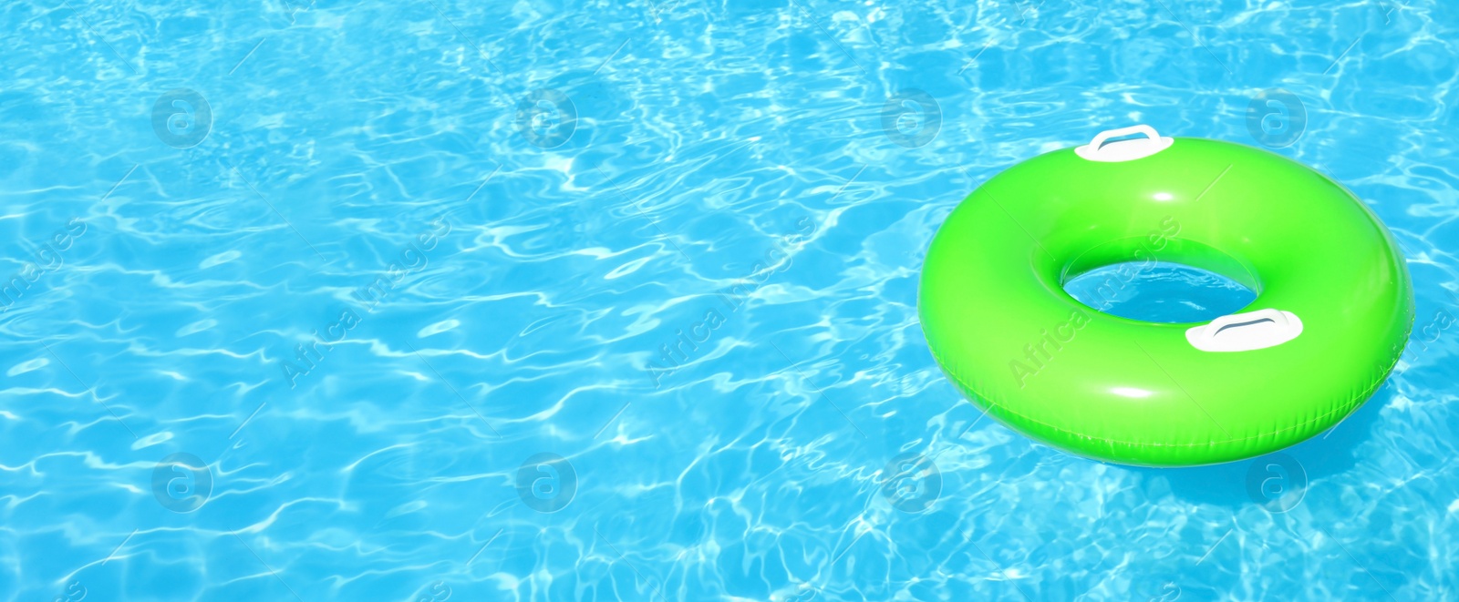 Image of Inflatable ring floating in swimming pool on sunny day, space for text. Banner design