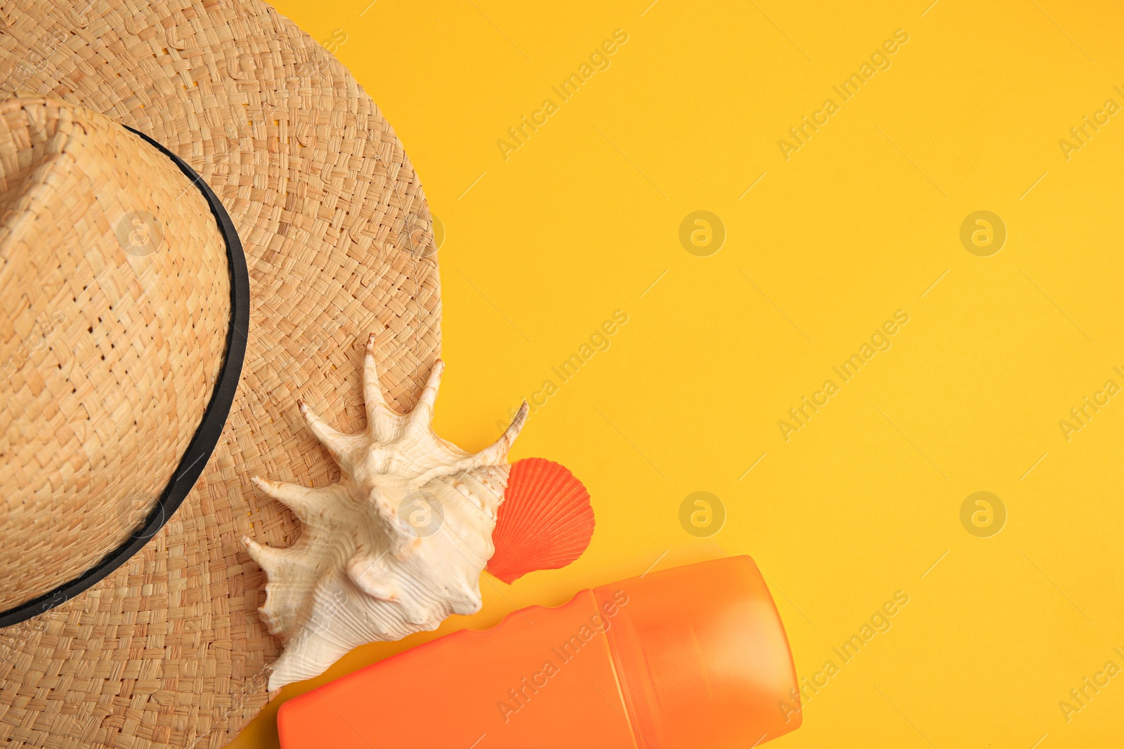 Photo of Flat lay composition with bottle of sunscreen on yellow background. Space for text